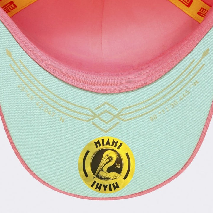 Under-visor close-up of 2025 Pirelli Miami GP Pink Cap with turquoise circuit coordinates print with Pelican decal