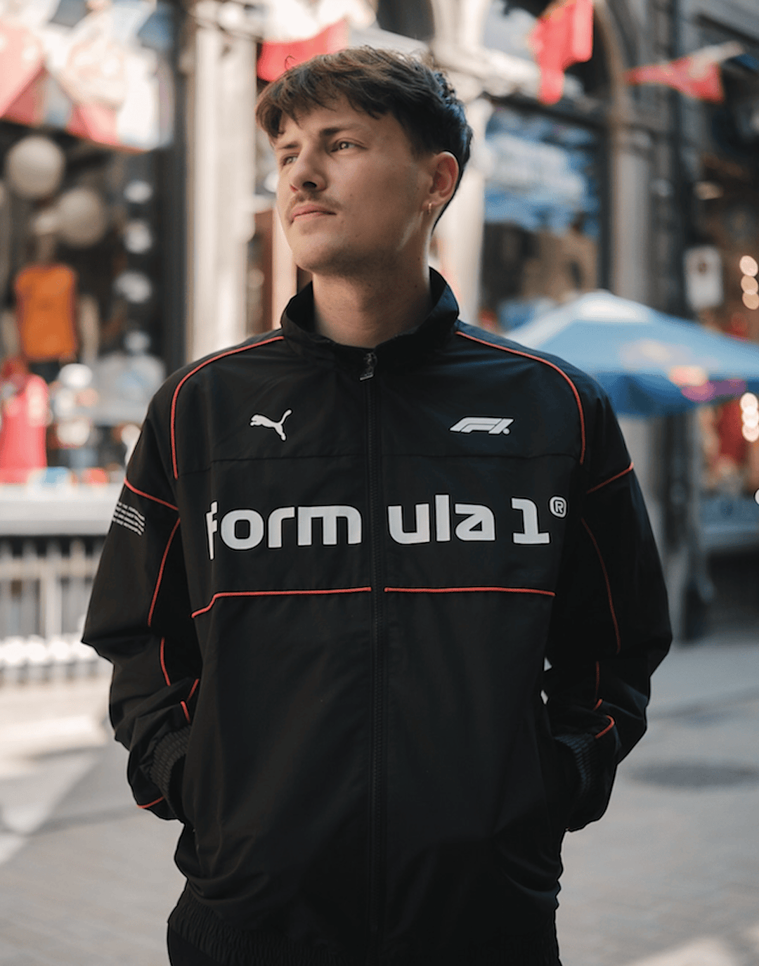 2025 PUMA X FORMULA 1™ Collection 75 Years Retro Racer Speed Driver Series SDS2.0 Men's jacket in black worn in front of FANABOX store in Old Montreal