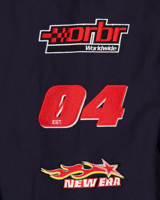 Close-up of the red 04 racing number and New Era motorsport embroidery on the black Red Bull Racing jacket showing the establishment of the Oracle RBR F1 Team in 2004. 