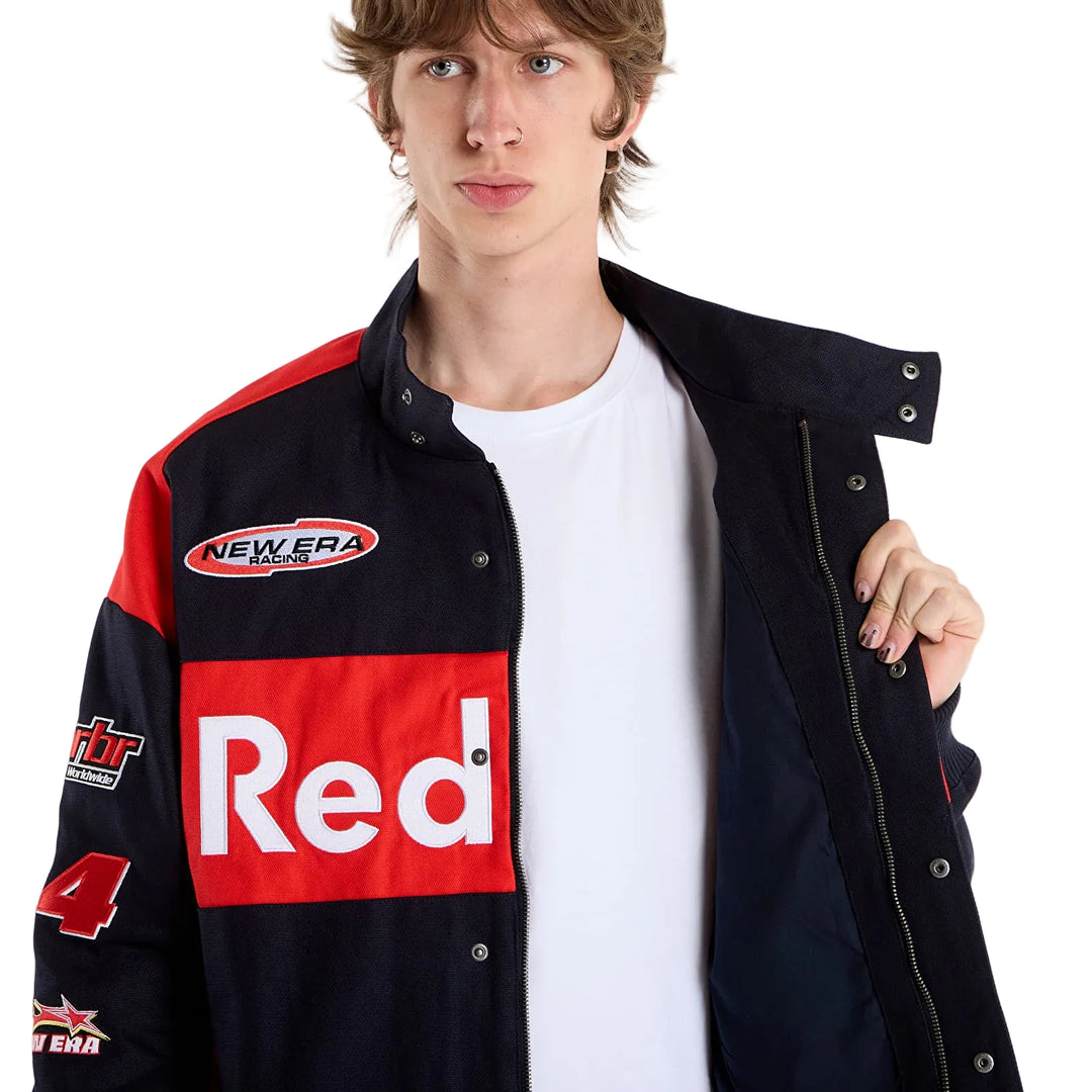 Male model wearing the black Red Bull Racing New Era jacket open over a white T-shirt, showing the front closure and team branding.