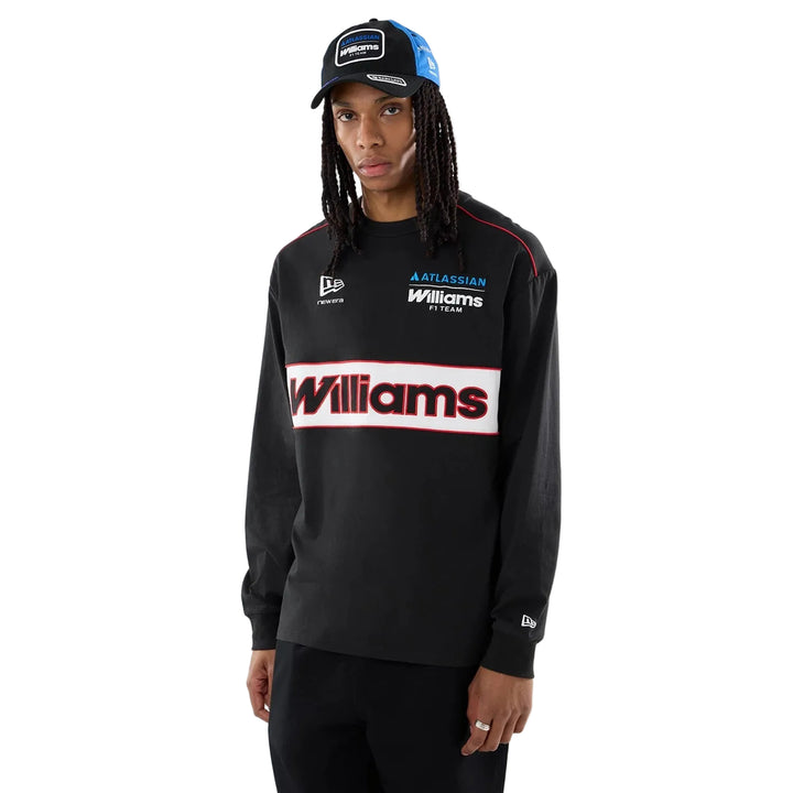 A Front view of the official 2026 Williams Racing F1 Las Vegas GP black long sleeve t-shirt.model wearing a black long-sleeve crewneck sweatshirt with a prominent white &