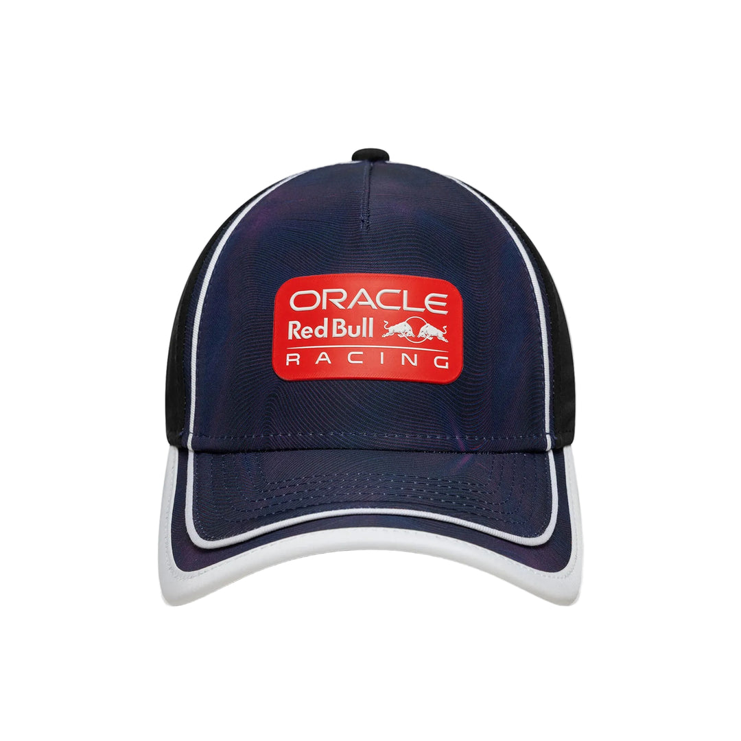 A dark navy blue Oracle Red Bull Racing baseball cap with a red front patch logo, white piping along the brim and side panels, and black mesh back panels, shown against a plain white background.