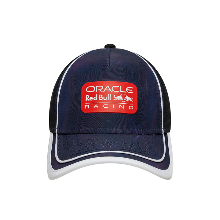 A dark navy blue Oracle Red Bull Racing baseball cap with a red front patch logo, white piping along the brim and side panels, and black mesh back panels, shown against a plain white background.