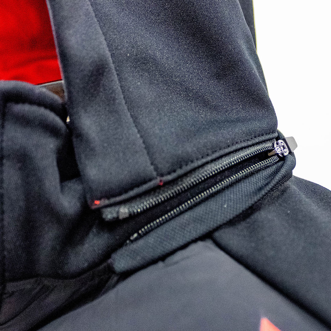 Close-up detail of the Ayrton Senna Race Unisex Jacket in black with zippered hood fully removable canope on a dark Senna jacket, showing the black zipper pull.