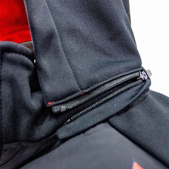 Close-up detail of the Ayrton Senna Race Unisex Jacket in black with zippered hood fully removable canope on a dark Senna jacket, showing the black zipper pull.
