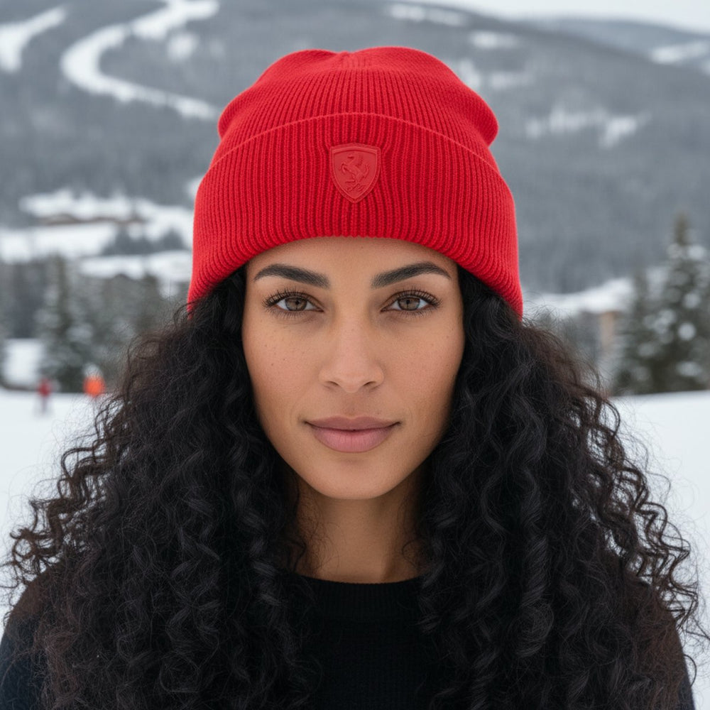 A woman wearing a Ferrari F1 red winter beanie in a Canadian snowy landscape