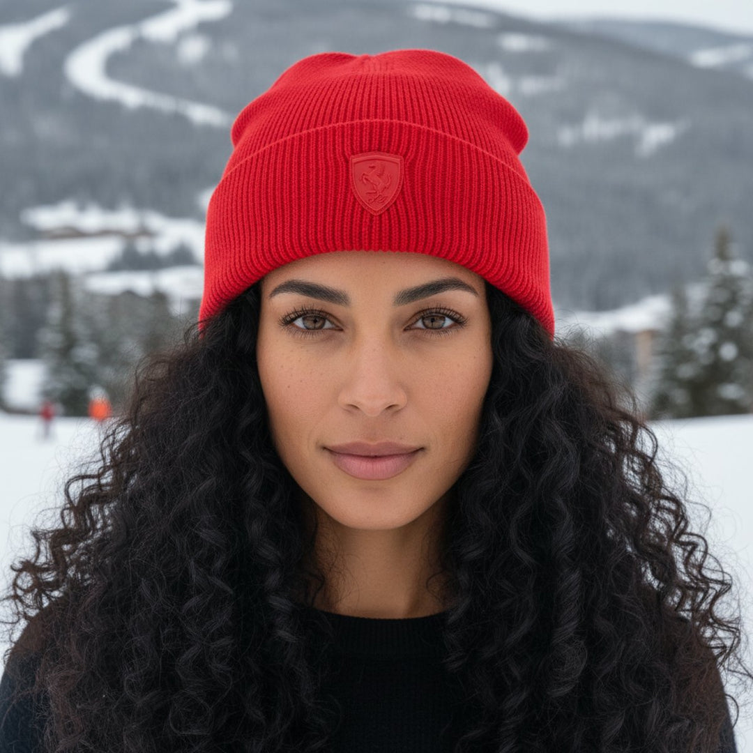 A woman wearing a Ferrari F1 red winter beanie in a Canadian snowy landscape
