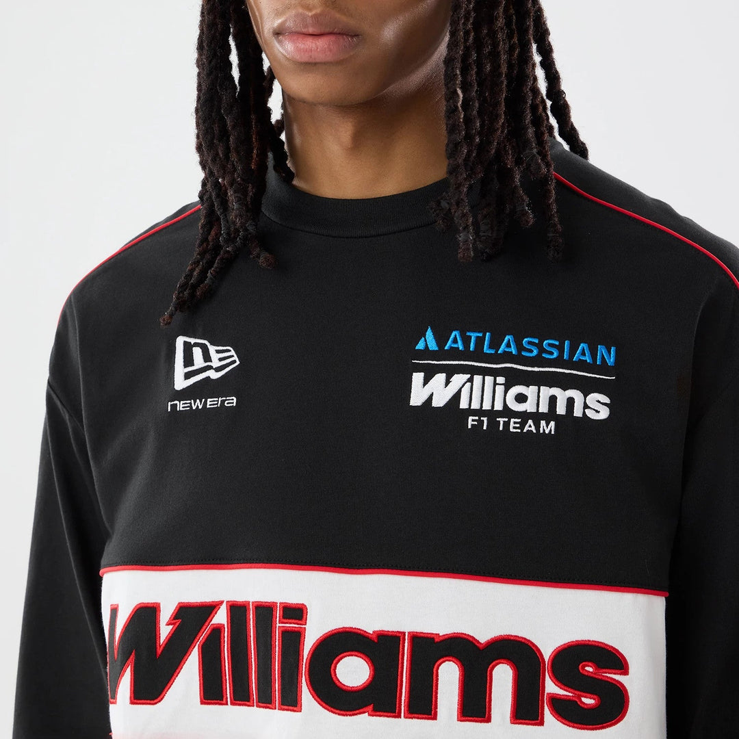 A close-up of a person wearing a black long-sleeve Male model wearing the official Williams Racing 2026 Las Vegas GP special edition long sleeve men&