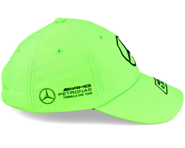 Fluorescent green cap with Mercedes AMG Petronas Formula One Team logos on a white background