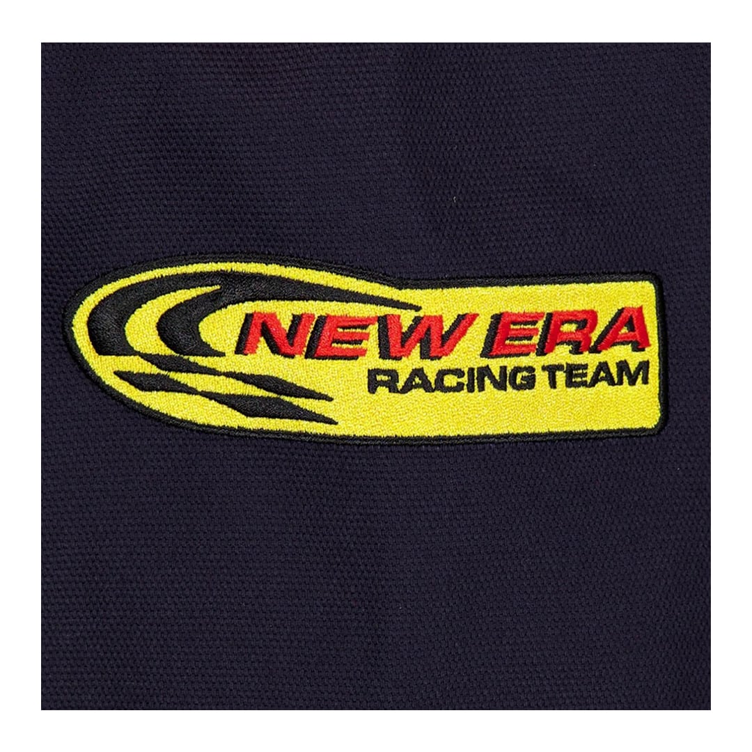 Close-up of the yellow and red New Era Racing Team embroidered patch on the black Red Bull Racing motorsport jacket.