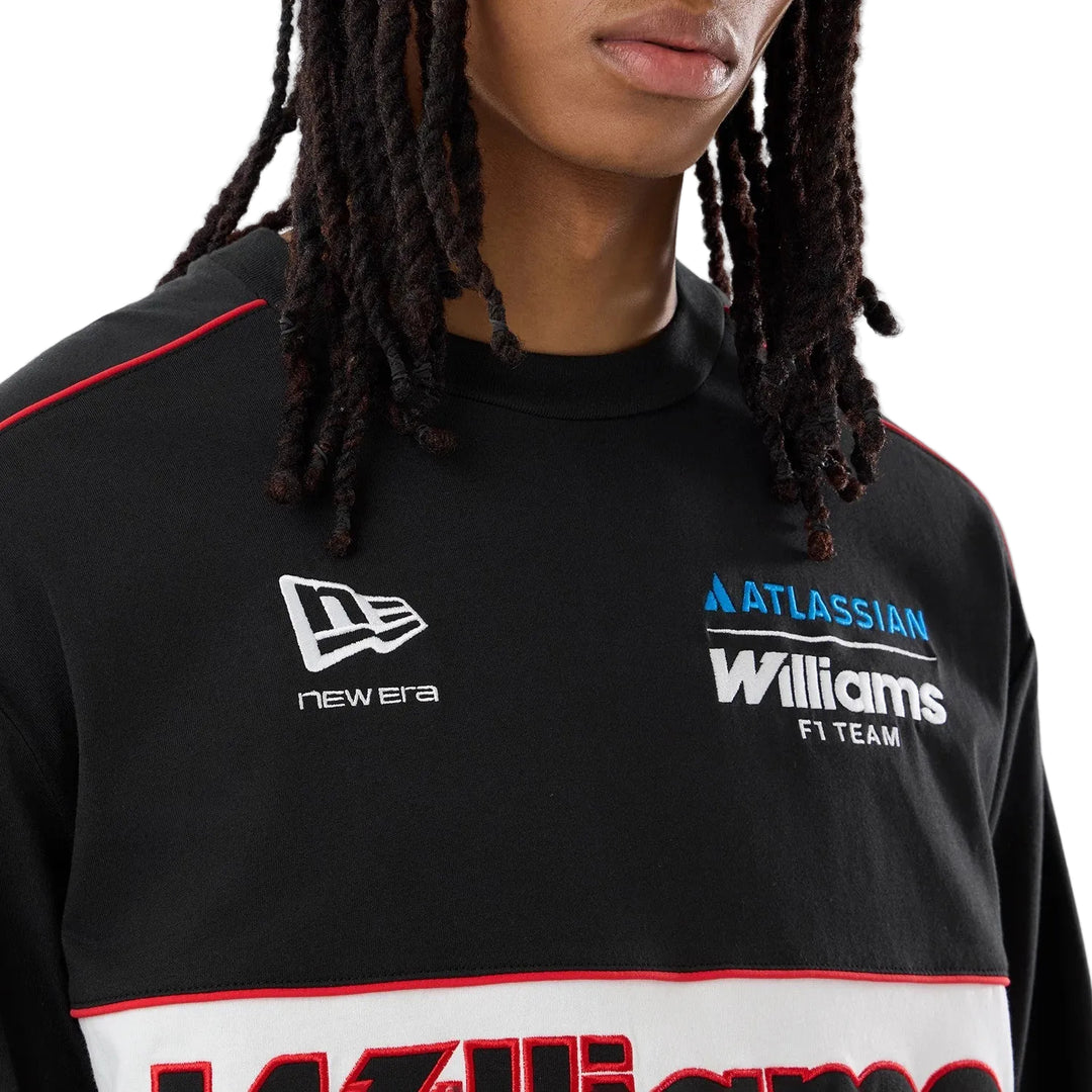 Close-up of the embroidered Atlassian Williams F1 Team script lettering on the front of the 2026 Vegas race special long sleeve tee with a crewneck with a wide white horizontal stripe across the chest. The men&