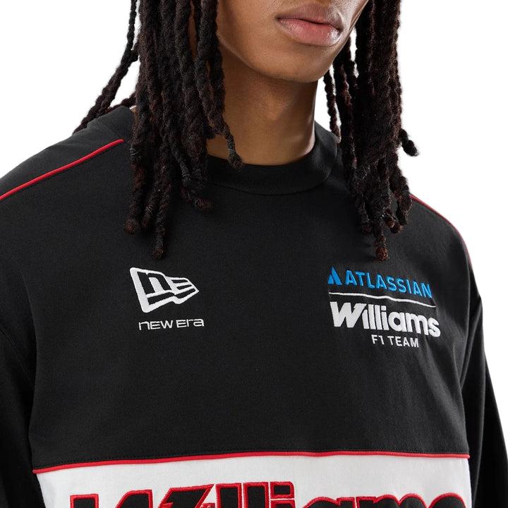 Close-up of the embroidered Atlassian Williams F1 Team script lettering on the front of the 2026 Vegas race special long sleeve tee with a crewneck with a wide white horizontal stripe across the chest. The men&