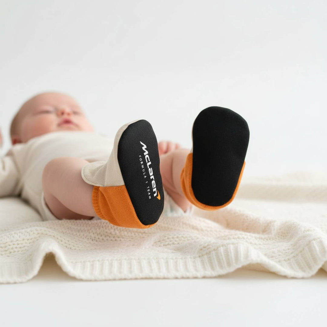 Newborn wearing McLaren F1 Team Baby Infant Creeper Crib Shoes Slippers - Beige, Black and Papaya Orange 