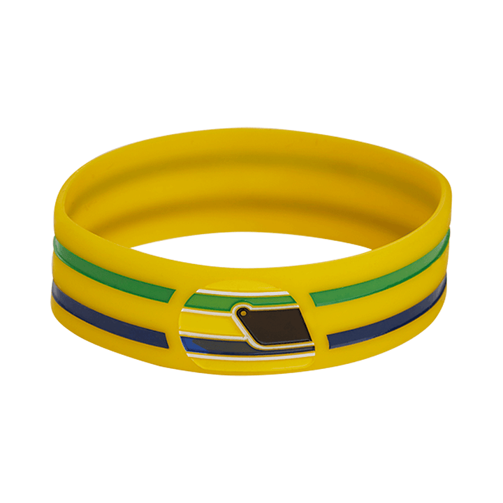 Official Ayrton Senna Brazil F1 Helmet Silicone wristband featuring a dominant Senna helmet and Brazilian flag colors with a yellow band with two accent bands in green and dark blue, shown against a plain white background.