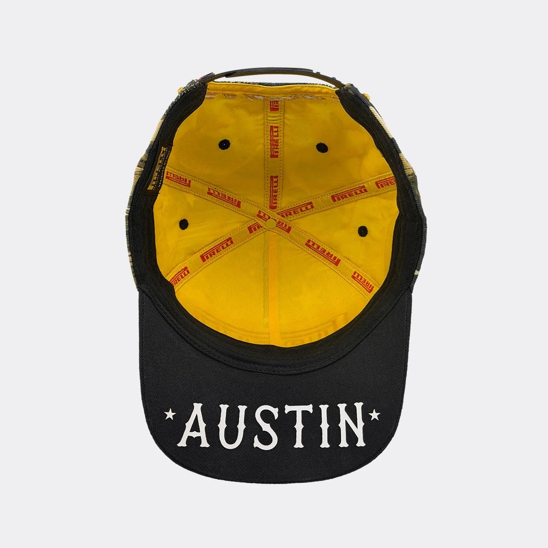 A black and yellow baseball 2026 Austin GP Pirelli F1 cap shown from the back, featuring &