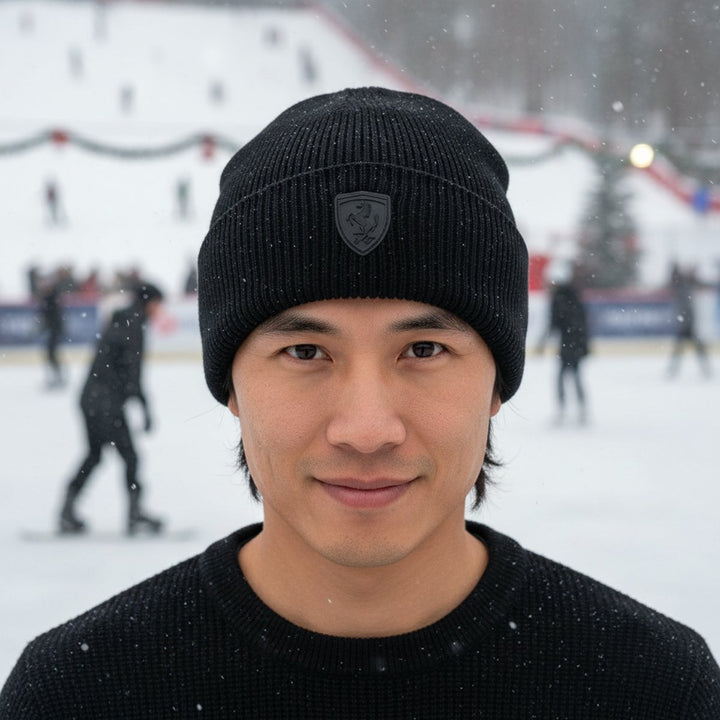 As an Asian male F1 fan wearing a Ferrari black knit beanie with a logo on an ice rink in the background