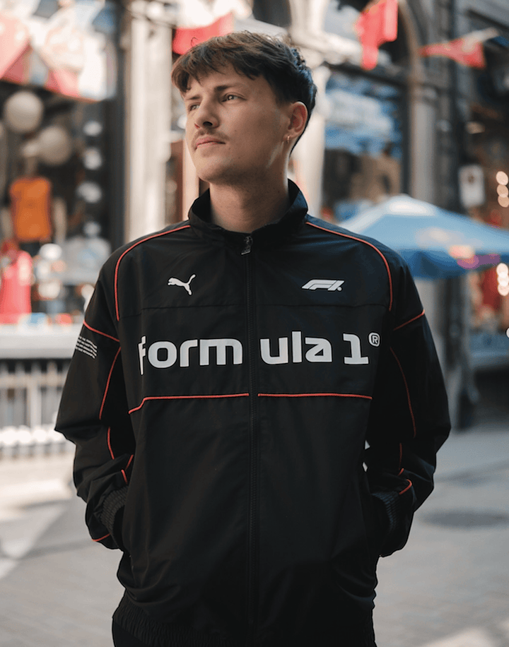 2025 PUMA X FORMULA 1™ Collection 75 Years Retro Racer Speed Driver Series SDS2.0 Men's jacket in black worn in front of FANABOX store in Old Montreal