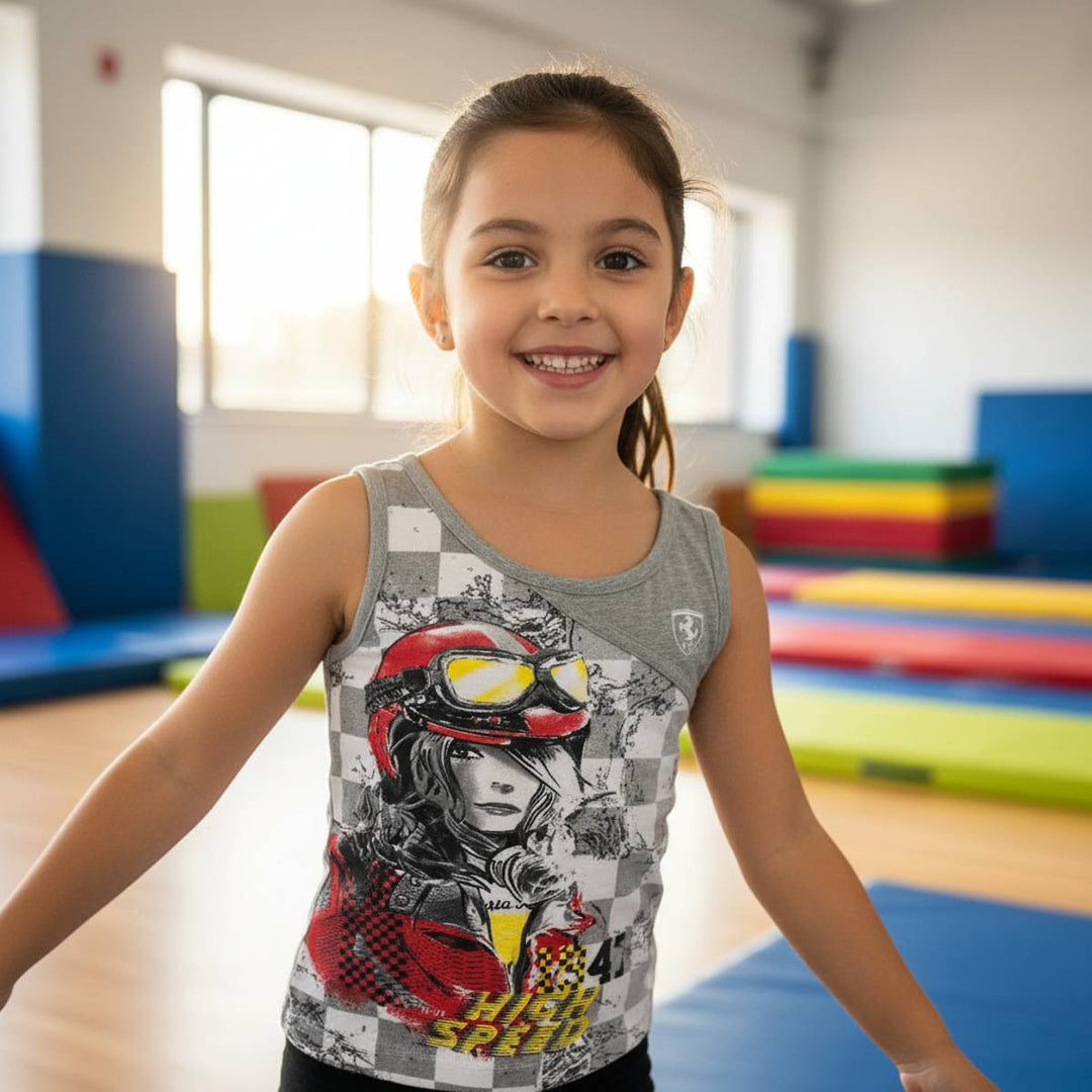 A young girl wearing a  Ferrari Checkered Print Tank top for Girls aged 2 to 11 years old with a high-speed graphic design in an indoor play area.