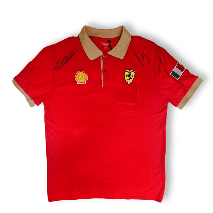 A red Scuderia Ferrari technical team men's factory polo shirt with white collar, featuring official team embroidery and two signature autographs of Scuderia Ferrari F1 Team Drivers Charles Leclerc and Carlos Sainz.