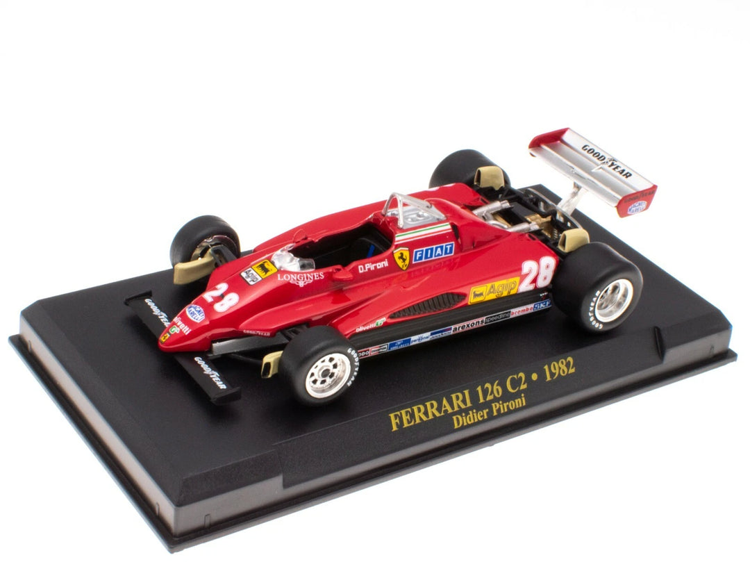 Model of a red Ferrari 126 C2 from 1982 on a black display stand with yellow text.