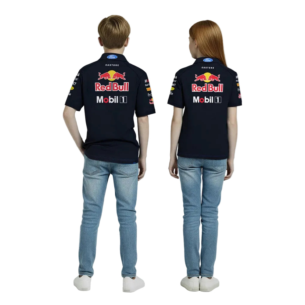 Two kids, a boy and a girl between the ages of 7 and 12 years old, wearing a 2026 Oracle Red Bull Racing F1 Team Set Up Polo - with sponsor logos on the front and back with a white background by Castore