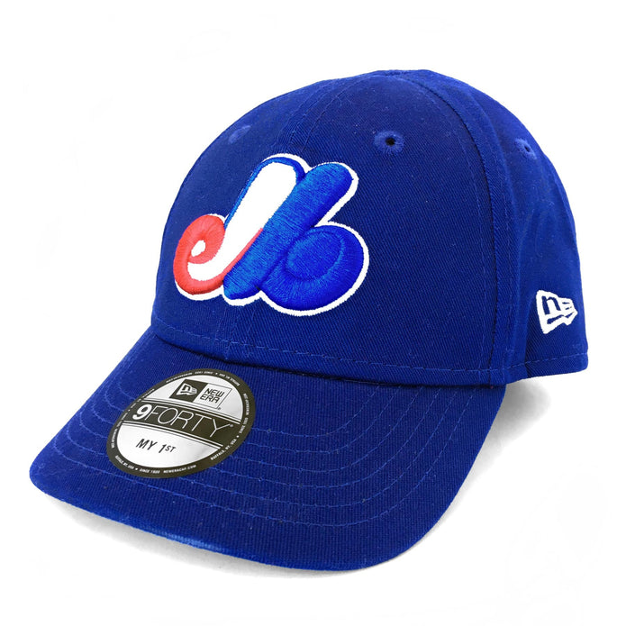 A toddler-sized blue baseball cap with the Montreal Expos logo embroidered on the front and back by New Era