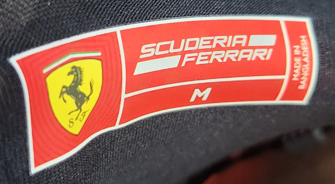 Detail of Scuderia Ferrari  authenticity label on Scuderia Ferrari women’s black F1 team t-shirt